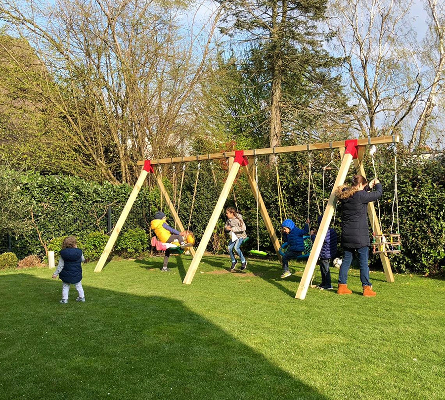 Kinder schaukeln im Garten